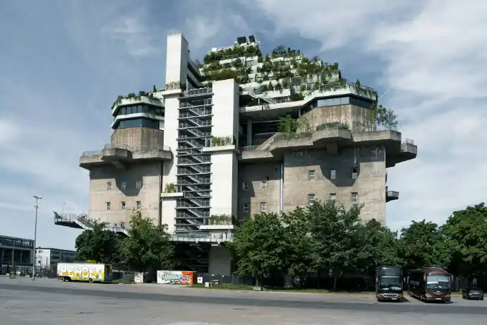 A large concrete building with a rooftop garden